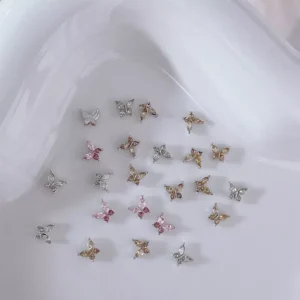 Elegant zircon butterfly charms scattered on a soft white curved dish