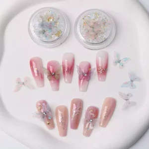 Butterfly nail decorations with pink gradient tips and rhinestones