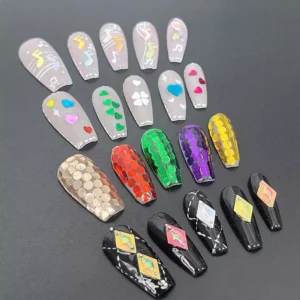 Finished nail art showing glitter sequins in shapes like notes, hearts, and diamonds
