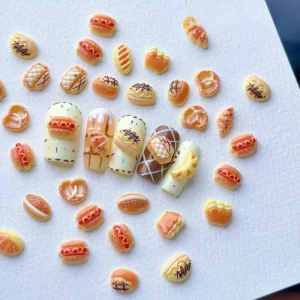 Finished nails decorated with various food-themed nail charms