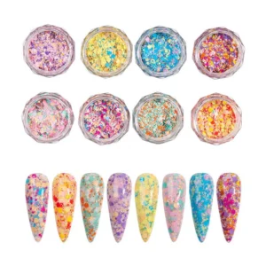 Eight glitter nail flakes with matching artificial nail tips