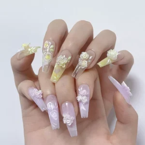 Hand model wearing pastel nail art with resin rose nail charms and butterflies
