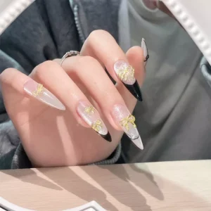 Elegant glitter nails with assorted gold bow nail charms