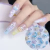 Funny monster nail charms in pastel tones applied to long nail tips with cartoon expressions