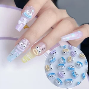 Funny monster nail charms in pastel tones applied to long nail tips with cartoon expressions