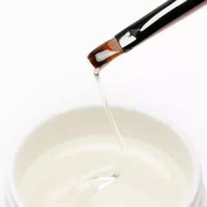 Clear builder gel on brush showing low viscosity and flow