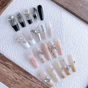Assorted crystal butterfly nail charms applied on glossy extension nails