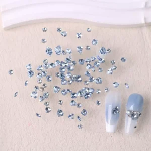 Gleaming nail rhinestones mix with irregular heart shapes on display with manicured nails