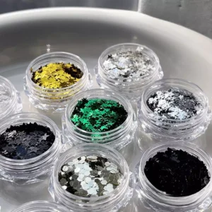 Close-up of green and silver star nail glitter sequins in pots