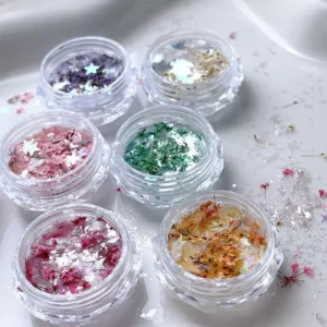 Assorted Shell Glitter Nail Charms with floral and star glitter spread on tray