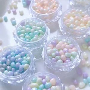 Close-up of dopamine pearl pebble nail decorations in soft multicolor hues