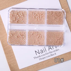 Multi-size glossy pearl nail beads in champagne color, organized in compartments