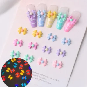Pastel Glow Bow Nail Charms in mixed colors displayed on nail tips and card