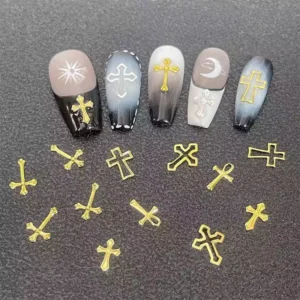 Gold cross nail studs shown with dark-tone nail designs