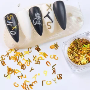 Gold holographic letter sequins with sample nail art on display