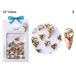 Gold champagne heart-shaped nail crystal on marble base