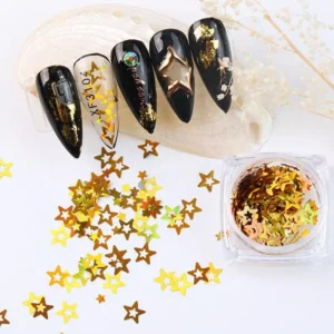 Close-up of gold star nail sequins in pot and on applied nail tips