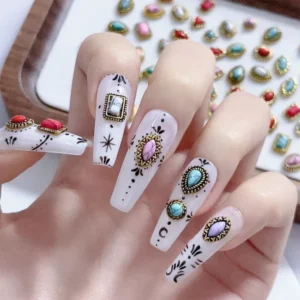 Close-up of gothic nails decorated with vintage turquoise and gemstone charms