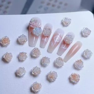 Gradient rose nail charms with iridescent pastel shimmer on clear nails