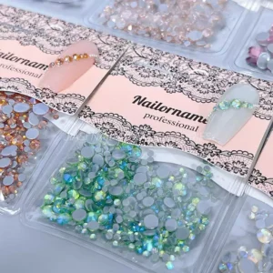Close-up of iridescent flatback nail gems in green tones with shimmer effect