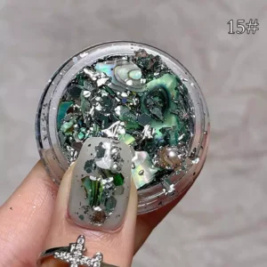 Green and metallic nail flakes with shimmering accents for luxury nail designs