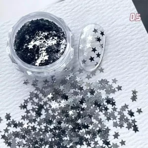 Dark silver metallic star-shaped nail glitter with bold contrast