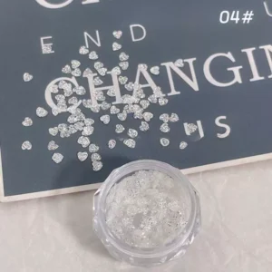 Small crystal heart nail sequins with glittery effect in transparent container