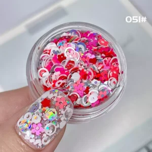Mix of heart and flower-shaped pink red nail glitter sequins with holographic accents