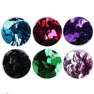 Heart shaped nail glitter in purple, green, pink, black, and blue metallic finishes