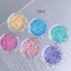 Heart and star nail art glitter in pink, purple, blue, and green hues.