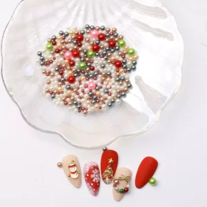Christmas pearl nail charms displayed in a white iridescent shell