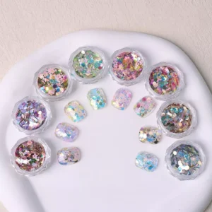 Holographic chunky glitter flakes with floral sequins in round jars on a white dish
