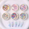 Holographic nail flower glitter in mixed colors with star and petal shapes, displayed with sample manicures