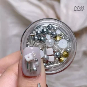 Nail art mix with white and silver pearls, studs, and rhinestones
