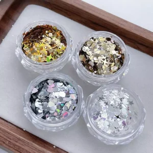 Four open jars of Aurora holographic nail sequins in silver, gold, bronze, and metallic black