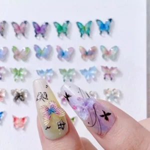 Close-up of two nails with 3D iridescent butterfly nail charms and black star detailing