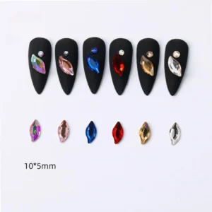 Marquise-shaped nail rhinestones in multiple colors on black nail samples