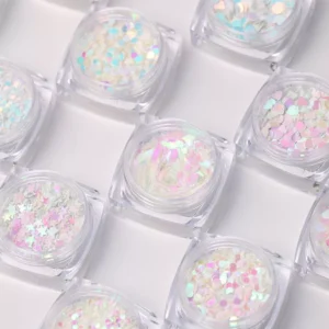 Close-up of iridescent nail sequins in star and round shapes