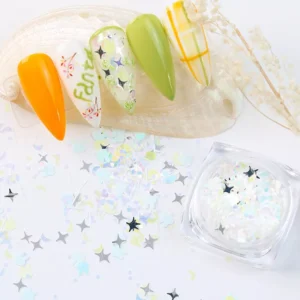 Close-up of moon and star shaped nail sequins in white tones