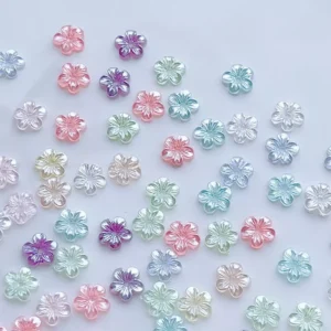 Fairy bloom flower nail charms in pastel colors, flat lay