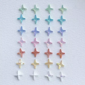 Iridescent 3D star nail charms in gradient colors arranged by row