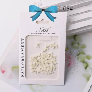 Creamy ivory bow nail decorations with diamond-like centers – glossy 3D nail embellishments