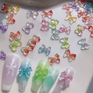 Jelly bow nail charms in glossy pastel colors shown on display and applied on nails
