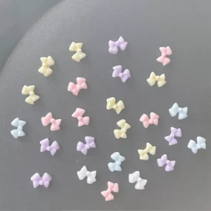 Jelly-style soft pastel resin bows laid out on a flat gray background