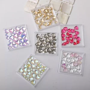 Jelly Heart Nail Crystals in mixed candy colors, iridescent heart charms in pink, gold, silver, and translucent tones