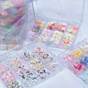 Stacked boxes filled with kawaii 3D nail accessories and anime-inspired charms