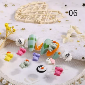 Dinosaur and penguin resin charms paired with soft green nails