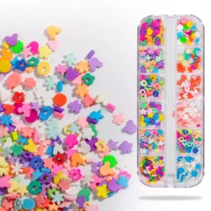 Assorted colorful kawaii nail charms spilled from storage box