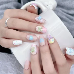 Multiple hand views of 3D bow nail charms applied in cute patterns