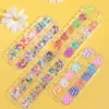 Mixed kawaii nail charms in fruit, flower, heart, and cartoon shapes inside a clear segmented case